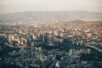 Fototapeta na wymiar Beautiful panoramic view of Tbilisi, Georgia. The city near the mountains.