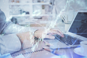 Multi exposure of stock market chart with man working on computer on background. Concept of...