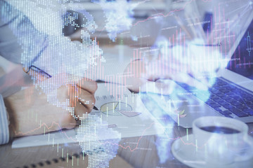 Multi exposure of stock market graph with man working on laptop on background. Concept of financial analysis.