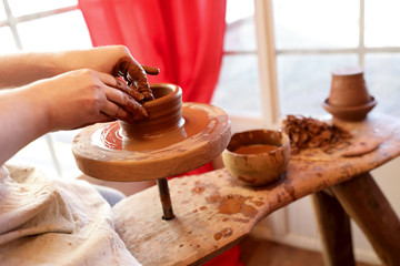 Potter works on pottery wheel