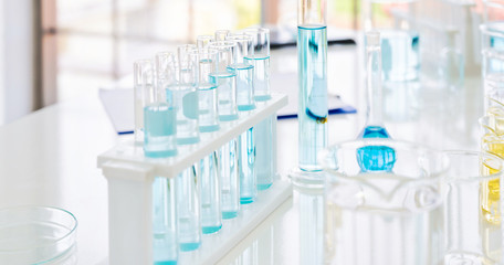 microscope with lab glassware, science laboratory research and development concept