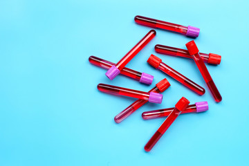 Blood in test tubes on blue background.