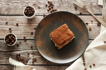 Tiramisu cake on a plate. Romantic composition with coffee and other elements