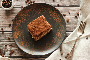Tiramisu cake on a plate. Romantic composition with coffee and other elements