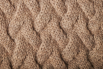 knitted carpet close -up. Textile texture on a white background. Detailed warm yarn background. Knit cashmere beige wool. Natural wool fabric, a fragment of a sweater.