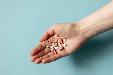 Covid-19 virus pandemic.Medicine pills and capsules in hand from coronavirus. Virus prevention and creating a vaccine against coronavirus. Medicine concept and health.