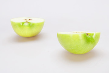 Closeup macro of two halves of a apple on the white