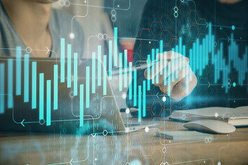 Forex graph with businessman typing on computer in office on background. Concept of analysis....