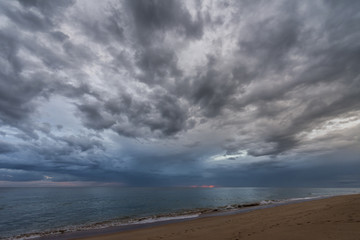 Dramatic, cloudy sky, sunset on the beach of Atlantic ocean in Portugal