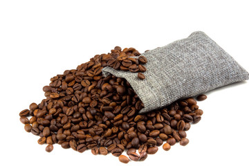 Roasted coffee beans spilling out from a burlap sack  isolated on a white background