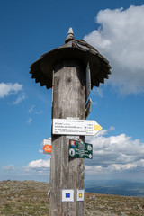 A tourist sigh on a wooden pole located on a top of the Babia Gora mountain