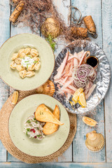 Several dishes of dumplings, slave, salad with crackers