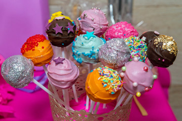 Beautifully decorated Cake pops. Table with sweets, buffet with cupcakes, candies, dessert.