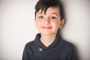 close portrait of a five years old boy over white