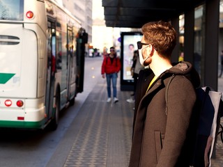 Man wearing FFP3 face protection mask, since new coronavirus Sars-CoV-2 and a flu have emerged waiting at the city bus.