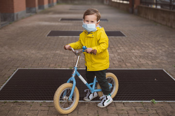 Baby kid with face surgical mask on during coronavirus, virus and flu outbreak. 