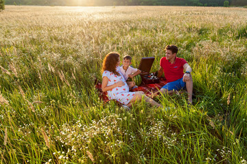 A happy family having a picnic in nature