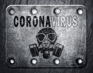 The inscription CORONAVIRUS on a rough sheet of metal