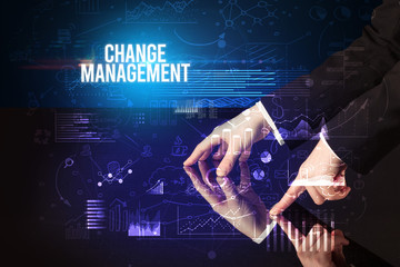 Businessman touching huge screen with CHANGE MANAGEMENT inscription, cyber business concept