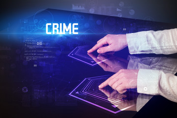 Hand touching digital table with CRIME inscription, new age security concept