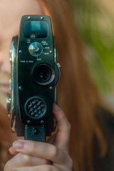 Young Woman Filmmaker Shooting With Retro Vintage Super 8 Film Camera
