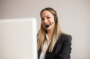 Young woman working in call center. Customer support woman in office