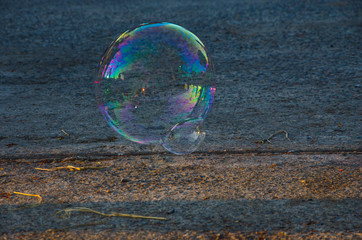Beautiful colors of reflections on air bubble skin over concrete floor