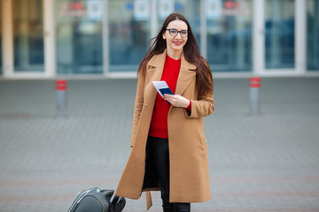 Young beautiful business woman suitcase in urban setting