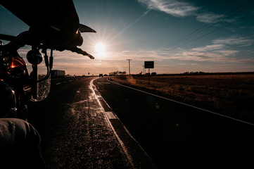 silhouette of man on bike at sunset
