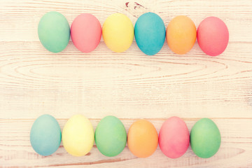 Easter fun background. Eggs on wooden texture