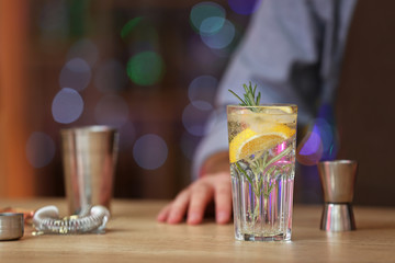Male bartender with tasty cocktail in pub
