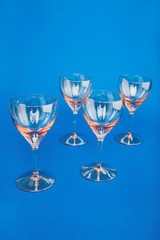 Empty glasses on blue background. Flat lay, copy space, top view.
