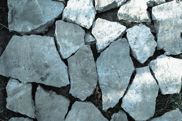 Obraz premium pieces of gray concrete on the ground, background and pattern