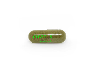 Capsules from medicinal plants contain the message Covid19 and antiviral herbs, isolated on a white background. Clipping path