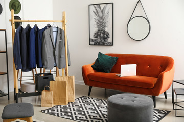 Interior of modern dressing room with stylish male clothes