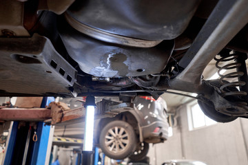 Rusty drum brakes, rear on red car. Change the old to new brake disc on car in a garage. Auto...