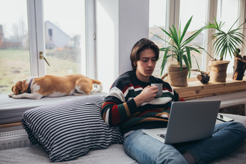 young man using laptop at home