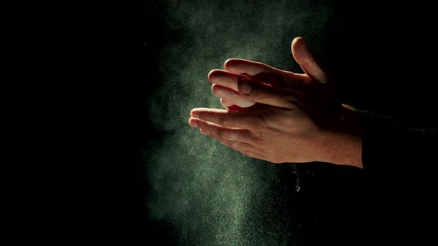 Gym concept, male claps hands with chalk