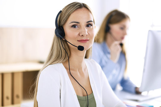 Portrait of call center operator at work. Group of people in a headset ready to help customers. Business concept