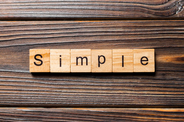 simple word written on wood block. simple text on table, concept