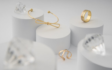 Modern golden bracelet and rings with brilliants on white paper cylinders