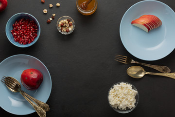 Fototapeta na wymiar Blue breakfast dishes on dark concrete. Nuts, honey, fruits. Healthy Cooking