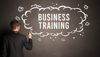 businessman drawing a cloud with BUSINESS TRAINING inscription inside, modern business concept