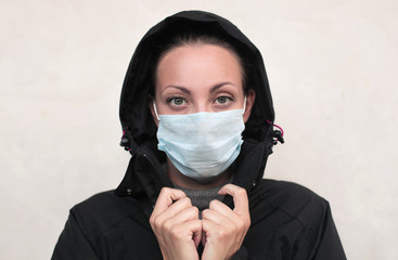 Woman wearing a winter jacket and a face protection mask