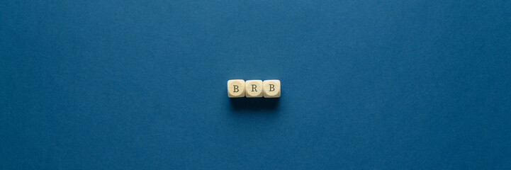 BRB abbreviation spelled on wooden dices