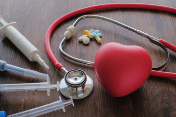 Medical background from pharmaceutical tablets and pills, stethoscope, heart and syringe. ...