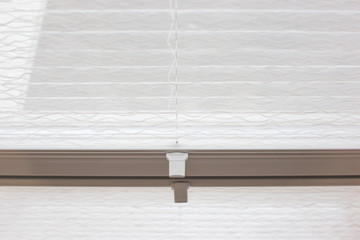 Pleated blinds close up on the window in the interior. Home blinds - cordless pleated modern shades...