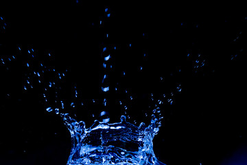 blue splash in the dark room