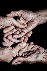 Fototapeta premium young man holding the hands of an old woman