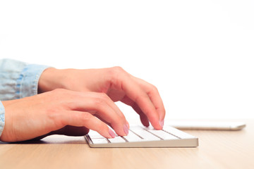 female hands type on a modern wireless keyboard on Office table  - Image